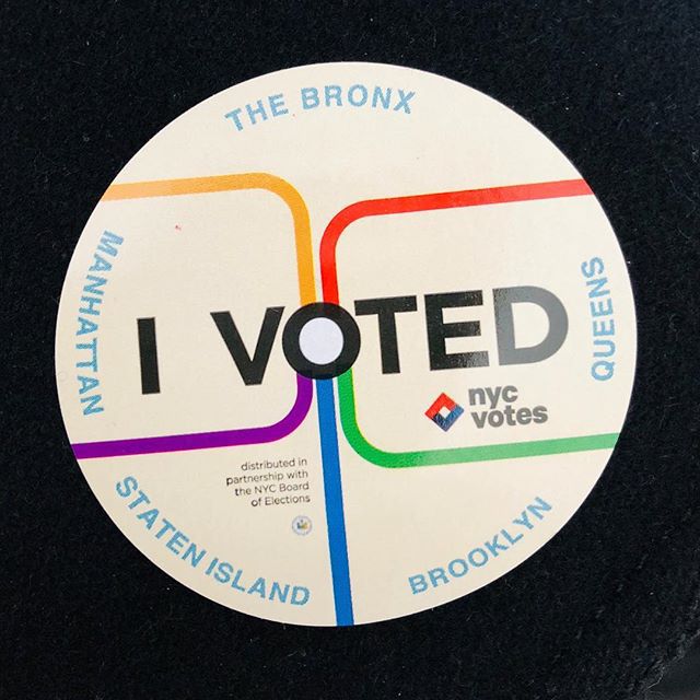 A circular sticker reading I voted, along with the names of the five boroughs. It depicts five colored lines similar to the subway map converging at the O, which is filled in like an express stop on a subway map.