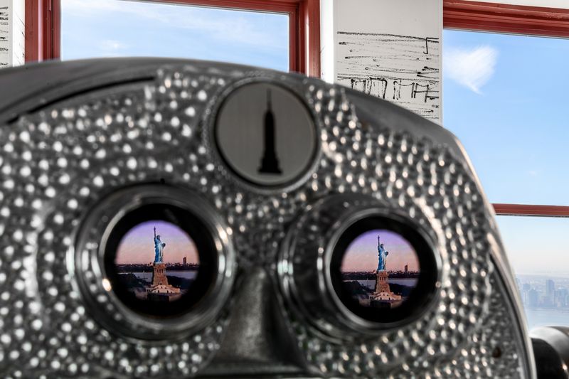 A binocular with views of the Statue of Liberty.