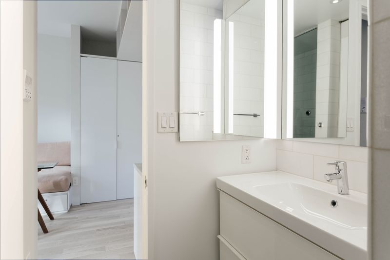 A bathroom with white walls.