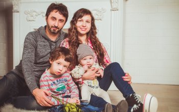 Family with a kid sitting on the floor